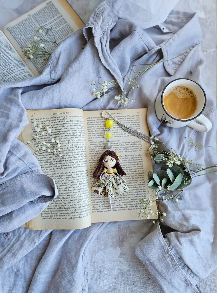 Bookmark doll on a book with coffee and eucalyptus