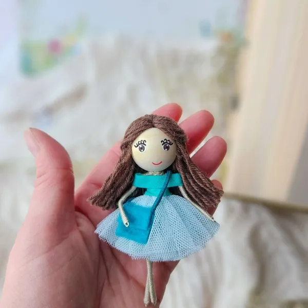 Bookmark doll in a turquoise dress