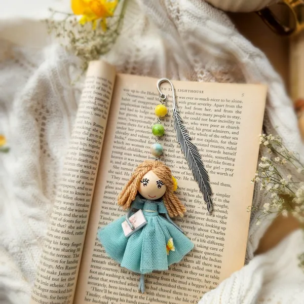 Bookmark doll on a book with spring flowers