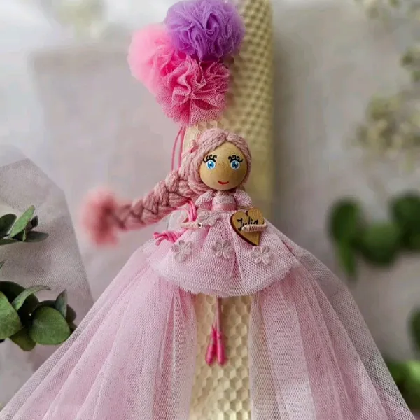 Baptism candle with a pink doll
