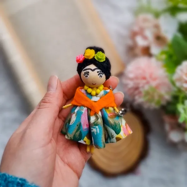 Frida-inspired doll on a wood slice