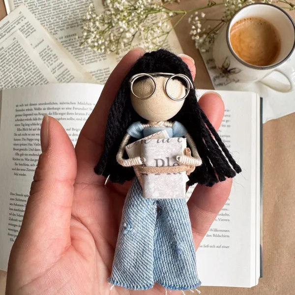 Doll holding a tiny DIY book