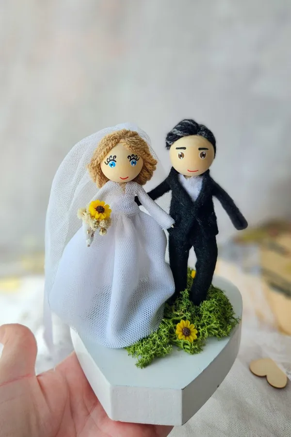 Bride and groom dolls on a white base
