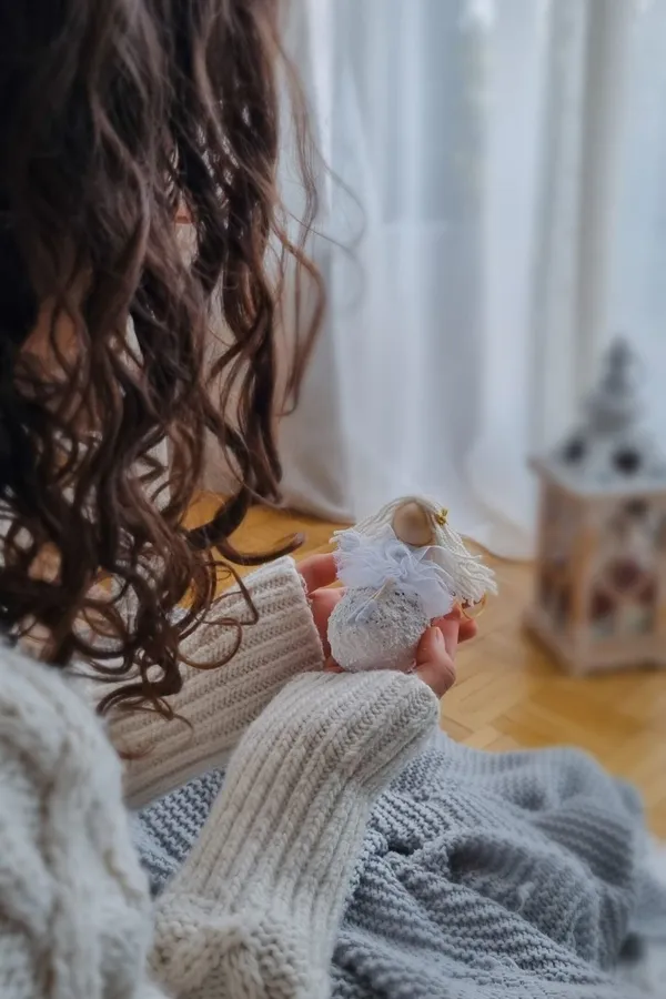 Christmas angel doll held by a child