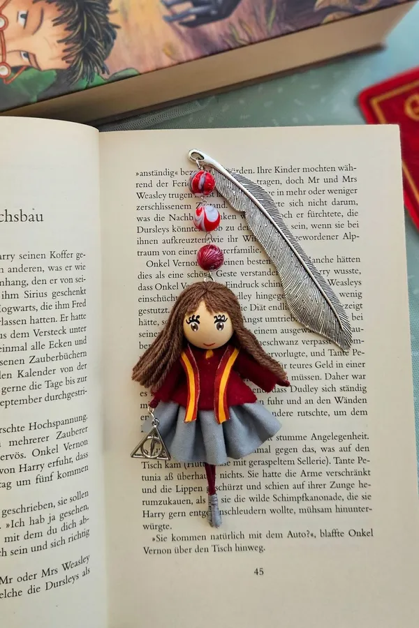 Bookmark doll in a school uniform on a book