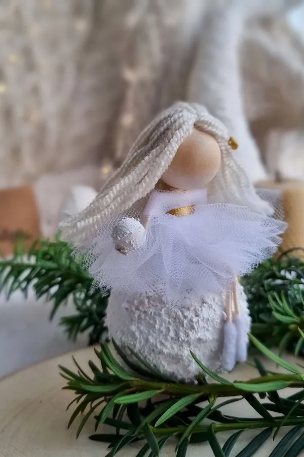Winter angel doll on fir branches