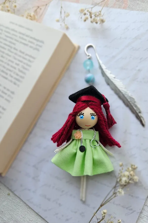 Graduate doll bookmark in a green dress