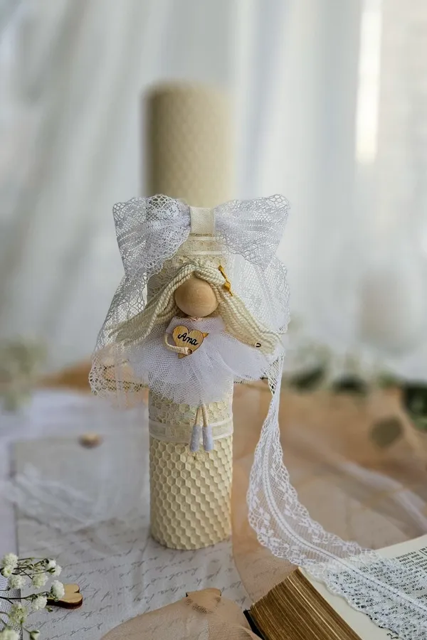 Baptism candle with a lace-veiled doll