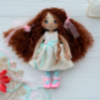 Handmade doll in bright clothes with natural hair