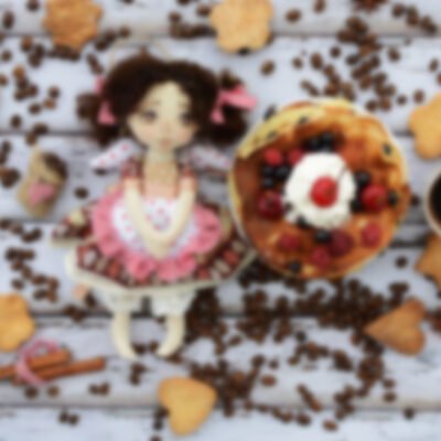 Handmade doll in brown clothes with natural hair